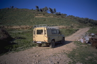 Image thumbnail: Landrover and fence of junked cars in zone 8 (A010)